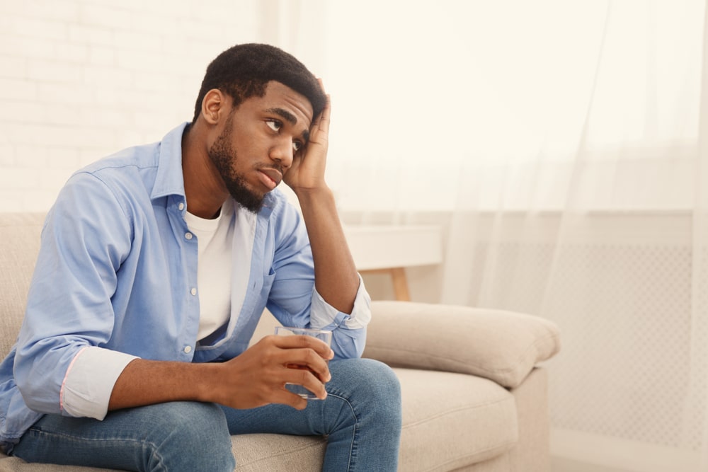 man drinking alcohol at home