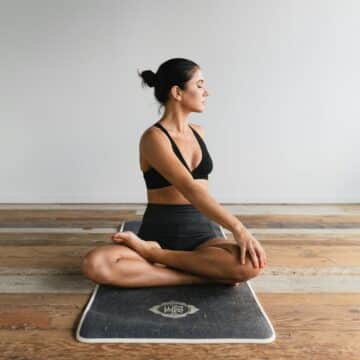 Photo of woman in fitness clothes on yoga mat