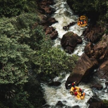 Two yellow rafts going through rapids