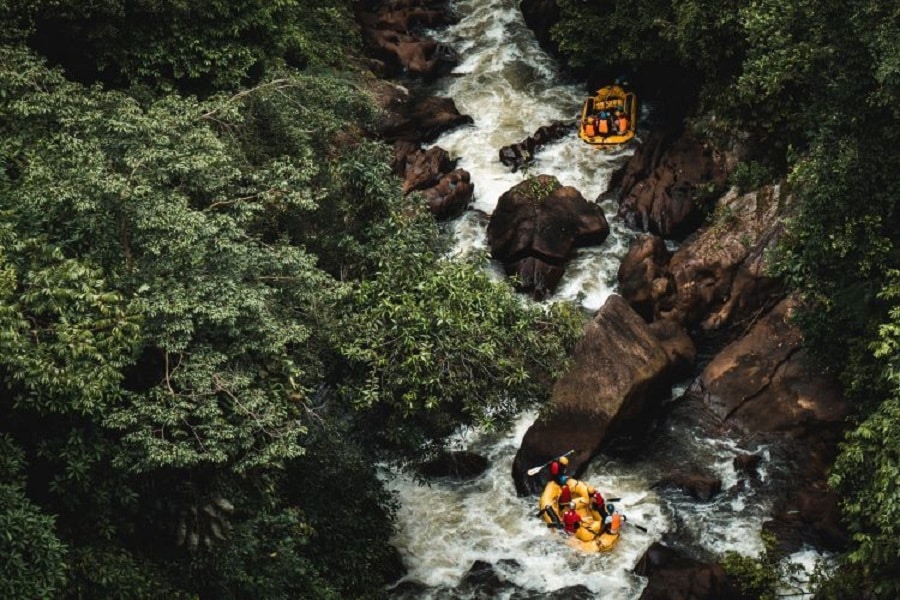 Two yellow rafts going through rapids