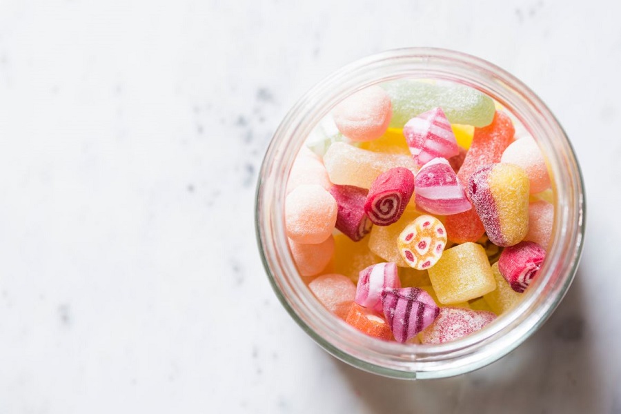 Glass jar full of colorful gummy candies