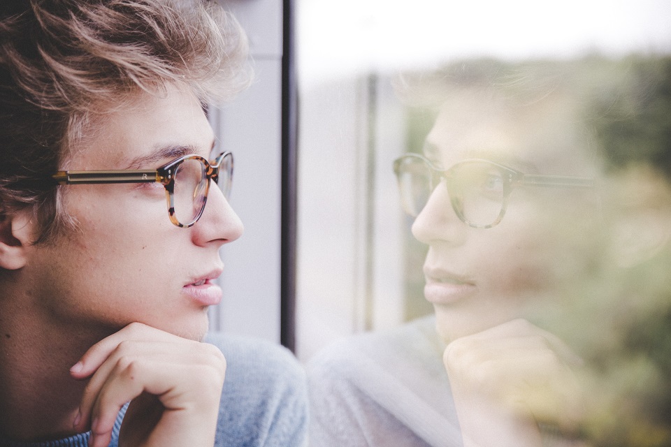 Teenager looking out the window