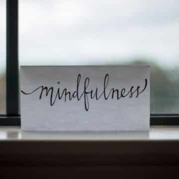 white paper with mindfulness written on it in front of a window