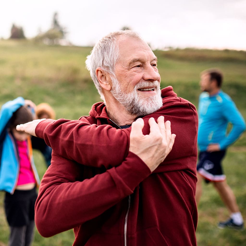 Functional medicine patient exercises outdoors as part of his maintenance and well-being plan.