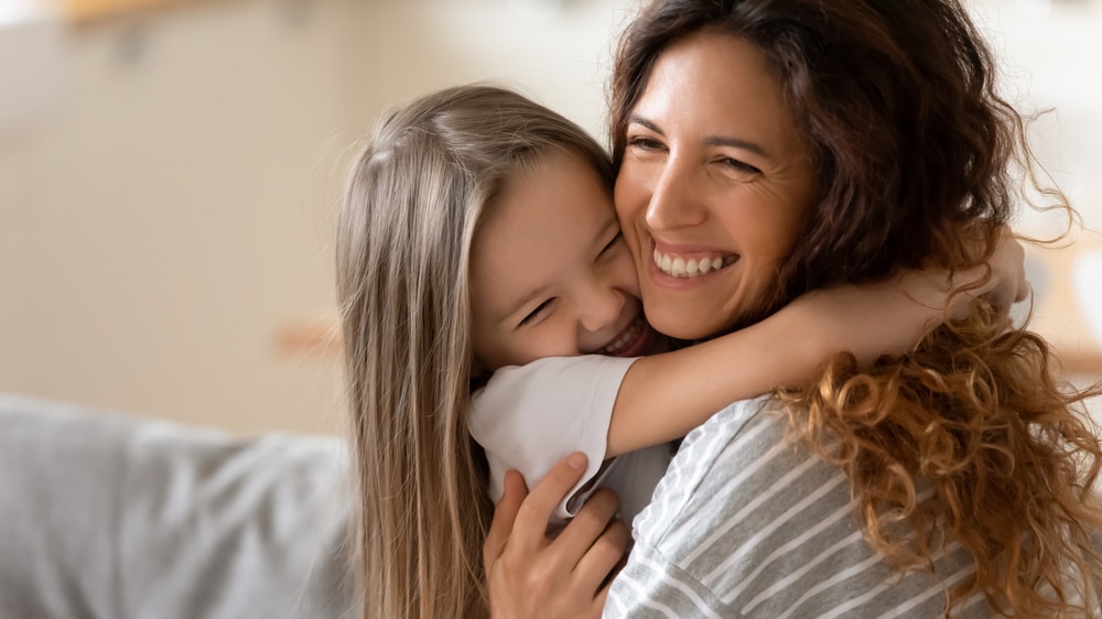 Little girl hugging her mom after getting neurotherapy