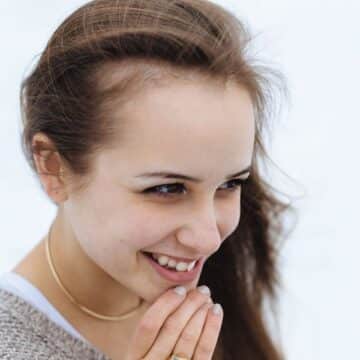 Woman touching her chin and smiling