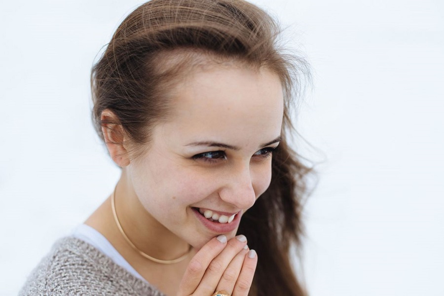 Woman touching her chin and smiling