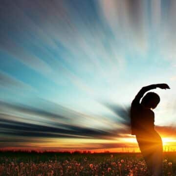 Person stretching in the sunset