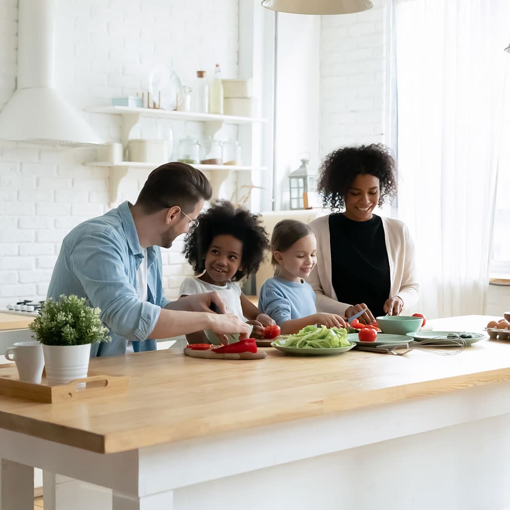 Healthy family prepares nutritious food as part of their functional medicine personalized plan